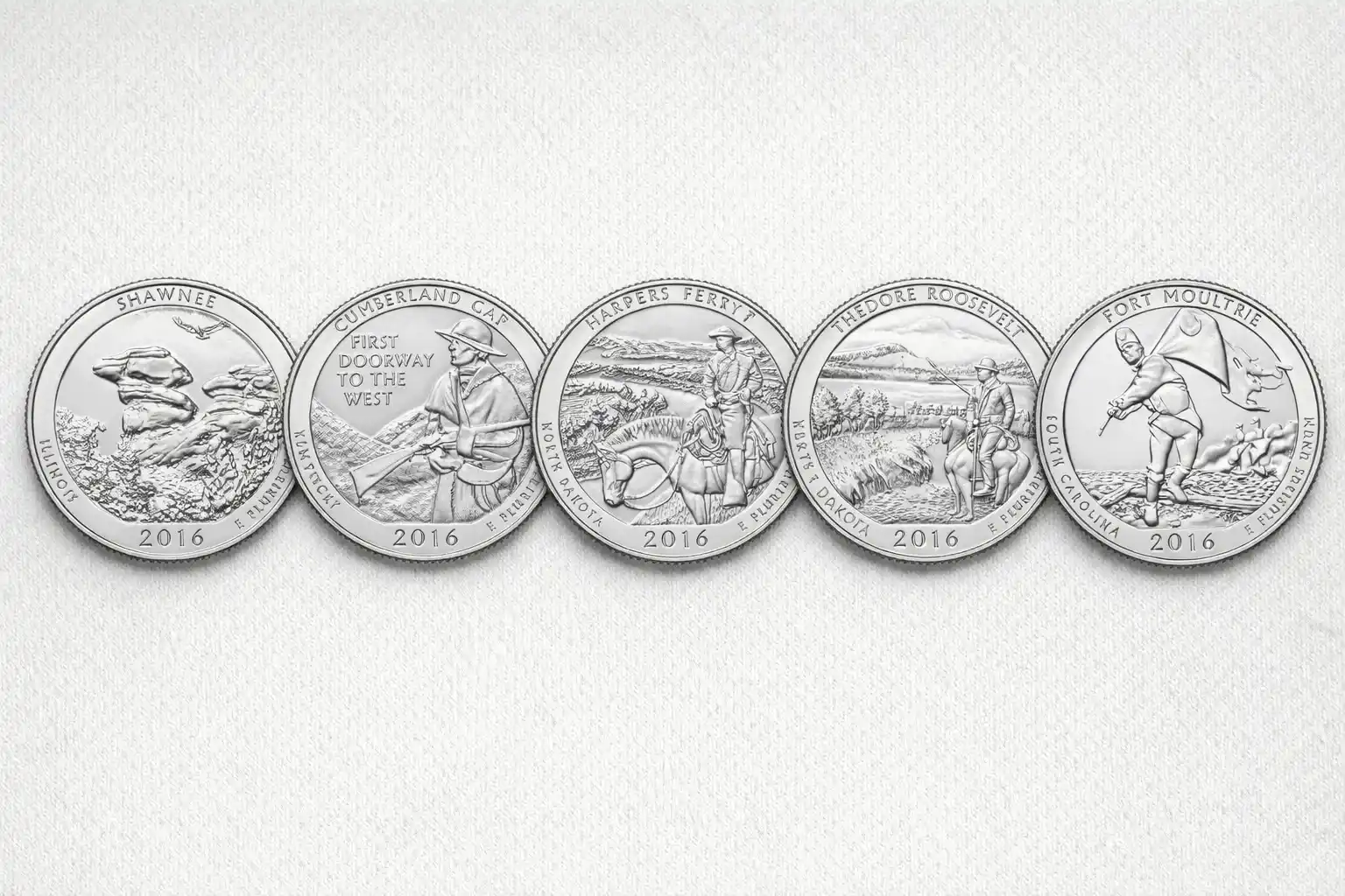 Five 2016 America the Beautiful quarter reverses on light gray background.